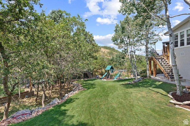 288 S Hillside Dr E, Elk Ridge, UT 84651 - view of yard with fence, stairs, and a playground
