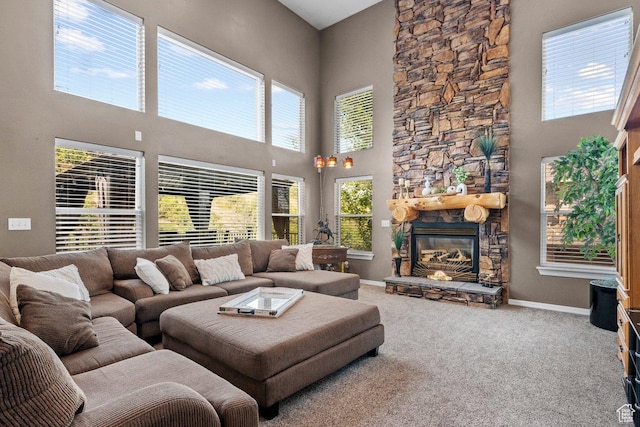 288 S Hillside Dr E, Elk Ridge, UT 84651 - living area with baseboards, carpet, a high ceiling, and a stone fireplace