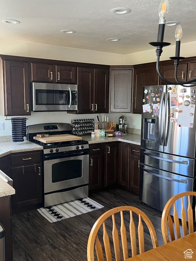 1013 N 740 W, Centerville, UT 84014 - kitchen featuring a textured ceiling, dark wood finished floors, appliances with stainless steel finishes, and dark brown cabinetry