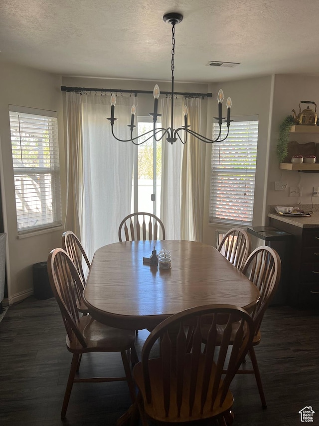 1013 N 740 W, Centerville, UT 84014 - dining area featuring a notable chandelier, dark wood-style floors, a textured ceiling, and visible vents