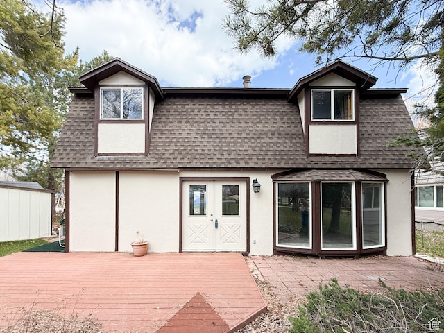 2160 N 730th St W, Garden City, UT 84028 - back of property featuring roof with shingles, stucco siding, mansard roof, and a deck