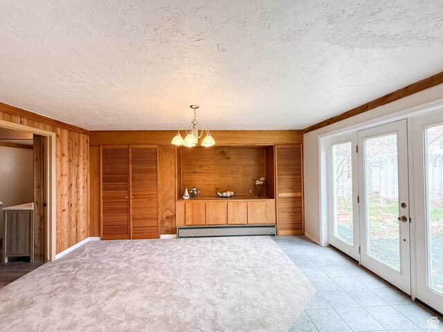 2160 N 730th St W, Garden City, UT 84028 - interior space featuring an inviting chandelier, a baseboard heating unit, wood walls, and a textured ceiling