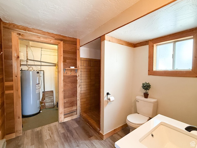 2160 N 730th St W, Garden City, UT 84028 - bathroom featuring a sink, toilet, a textured ceiling, water heater, and wood finished floors