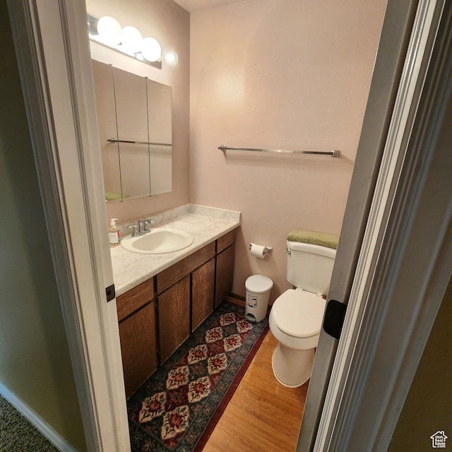 365 E Main St, Grantsville, UT 84029 - half bathroom featuring vanity, baseboards, toilet, and wood finished floors