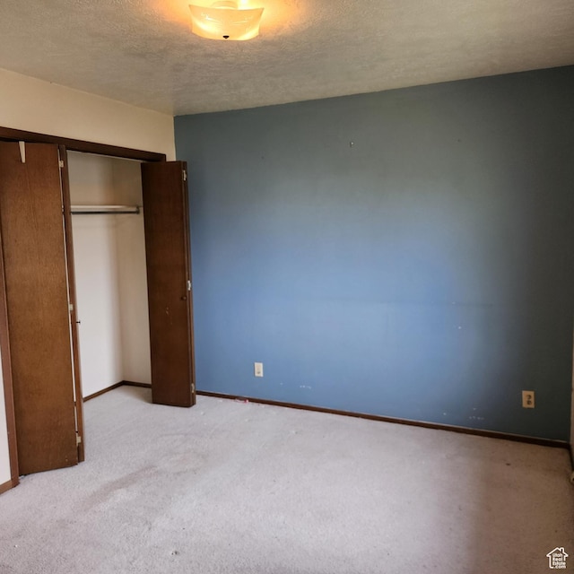 365 E Main St, Grantsville, UT 84029 - unfurnished bedroom with a closet, a textured ceiling, baseboards, and light carpet
