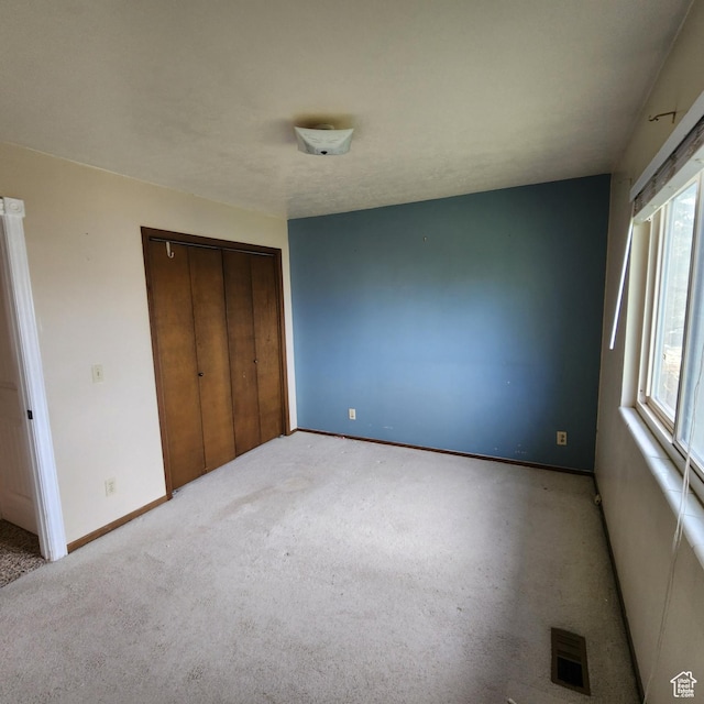 365 E Main St, Grantsville, UT 84029 - unfurnished bedroom featuring baseboards, carpet, a closet, and visible vents