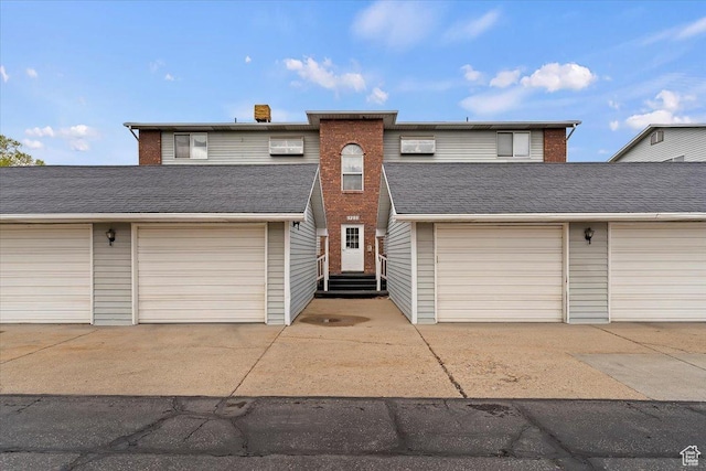 view of front of house featuring community garages and entry steps