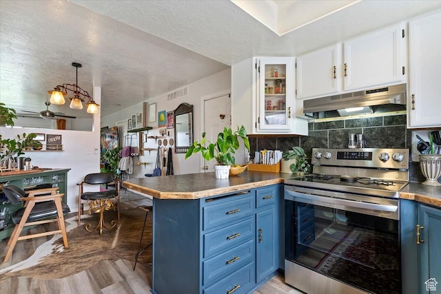 kitchen featuring electric range, a kitchen breakfast bar, under cabinet range hood, white cabinets, and blue cabinetry