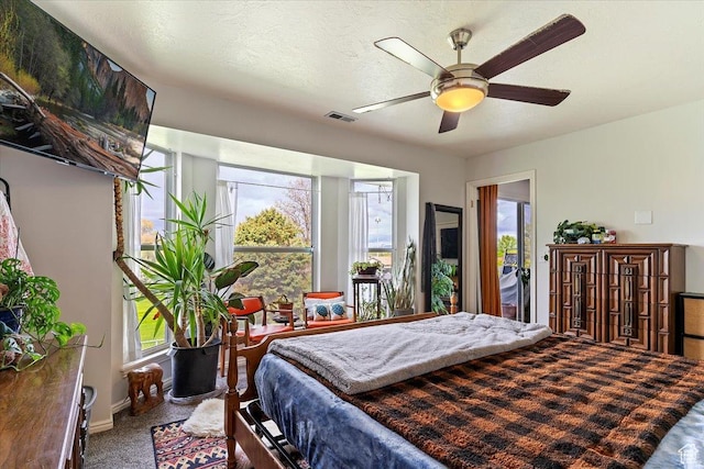 bedroom featuring carpet flooring, ceiling fan, and visible vents