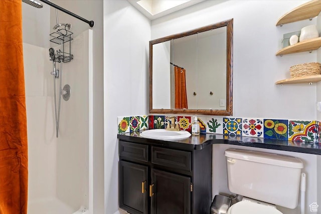 bathroom featuring toilet, decorative backsplash, curtained shower, and vanity