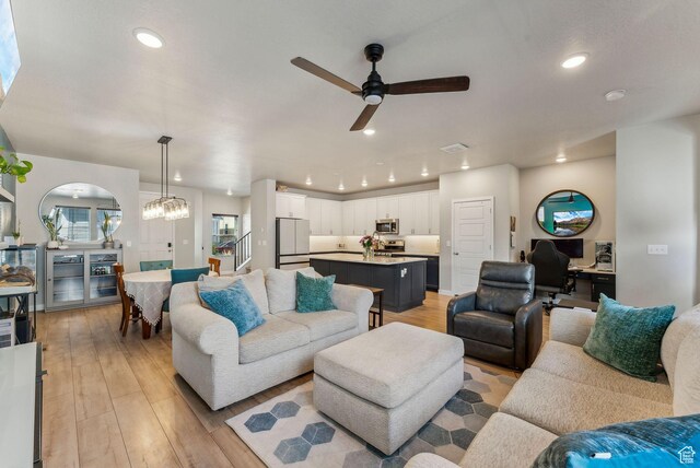 11619 S Silver Pond Dr W, South Jordan, UT 84009 - living room with recessed lighting, light wood-style flooring, ceiling fan with notable chandelier, and visible vents