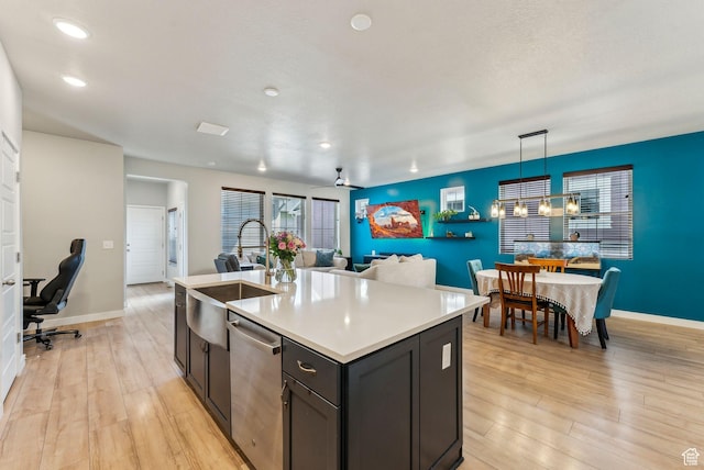 11619 S Silver Pond Dr W, South Jordan, UT 84009 - kitchen with a sink, light wood finished floors, light countertops, stainless steel dishwasher, and a center island with sink