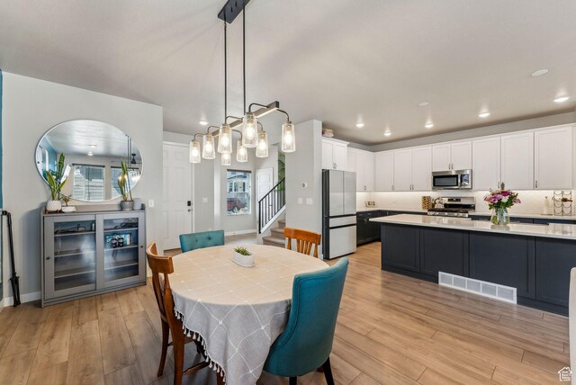 11619 S Silver Pond Dr W, South Jordan, UT 84009 - dining room with recessed lighting, visible vents, light wood-style flooring, and stairway
