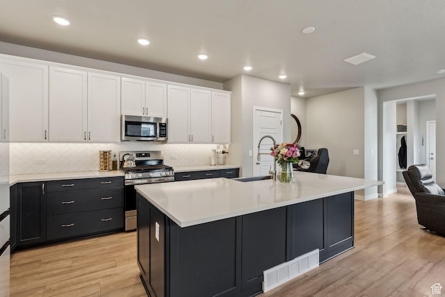 11619 S Silver Pond Dr W, South Jordan, UT 84009 - kitchen featuring visible vents, appliances with stainless steel finishes, a sink, light countertops, and white cabinetry