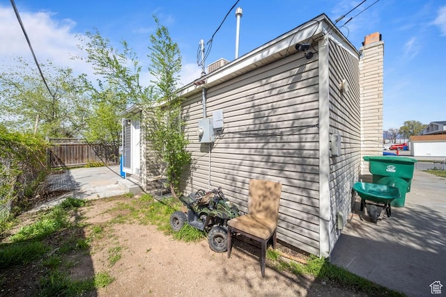 5390 S 4460 W, Kearns, UT 84118 - view of home's exterior with fence and a chimney