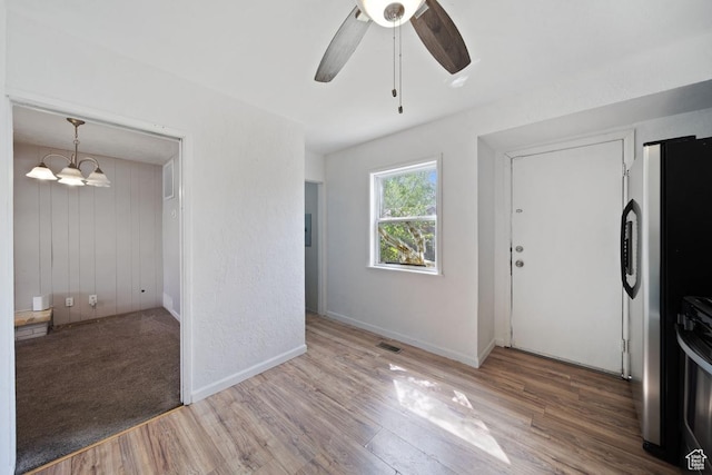 5390 S 4460 W, Kearns, UT 84118 - foyer entrance featuring baseboards, visible vents, wood finished floors, and ceiling fan with notable chandelier