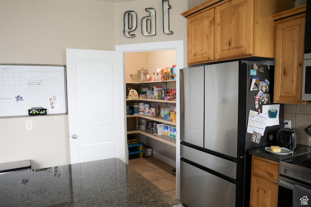 7044 W 8050 S, West Jordan, UT 84081 - kitchen with backsplash, stainless steel appliances, tile patterned flooring, and dark stone countertops