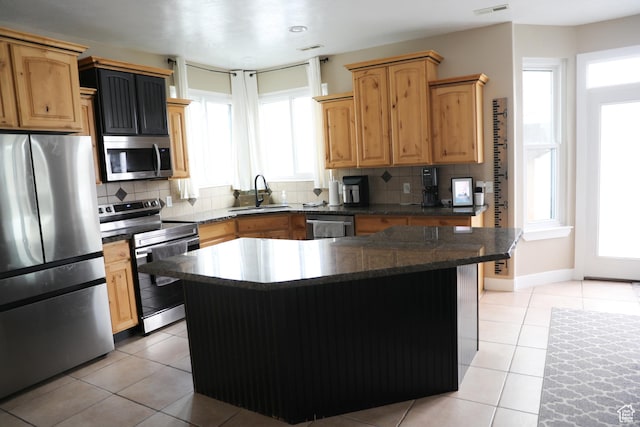 7044 W 8050 S, West Jordan, UT 84081 - kitchen featuring a sink, appliances with stainless steel finishes, backsplash, and a wealth of natural light