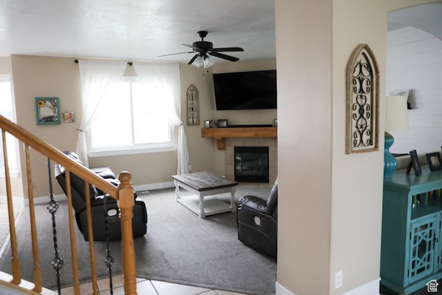 7044 W 8050 S, West Jordan, UT 84081 - carpeted living area featuring a tiled fireplace, baseboards, ceiling fan, and stairway