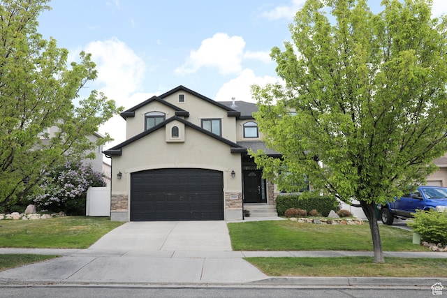 7044 W 8050 S, West Jordan, UT 84081 - view of front of property featuring concrete driveway, stucco siding, stone siding, and a front lawn
