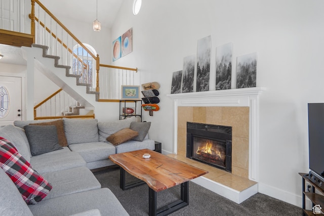 6888 S Hillside Village Cir, Salt Lake City, UT 84121 - carpeted living room featuring a fireplace, a high ceiling, and stairway