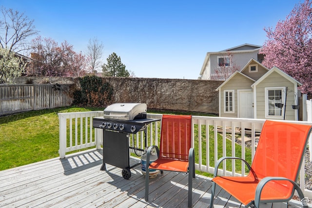 6888 S Hillside Village Cir, Salt Lake City, UT 84121 - wooden terrace with a fenced backyard, a yard, and grilling area