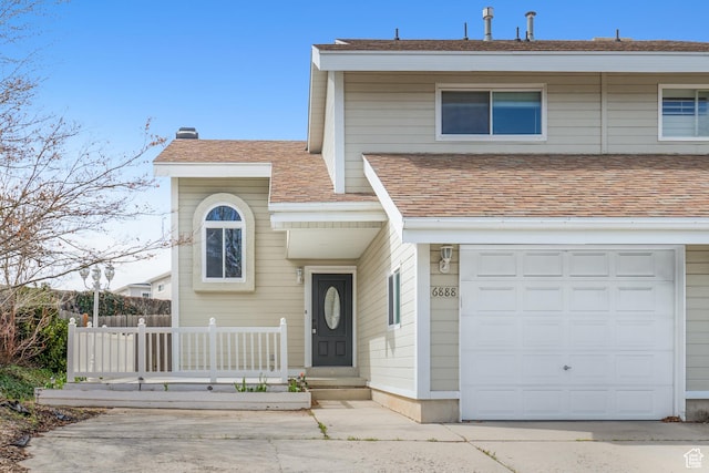 6888 S Hillside Village Cir, Salt Lake City, UT 84121 - traditional home featuring fence, a chimney, roof with shingles, and a garage