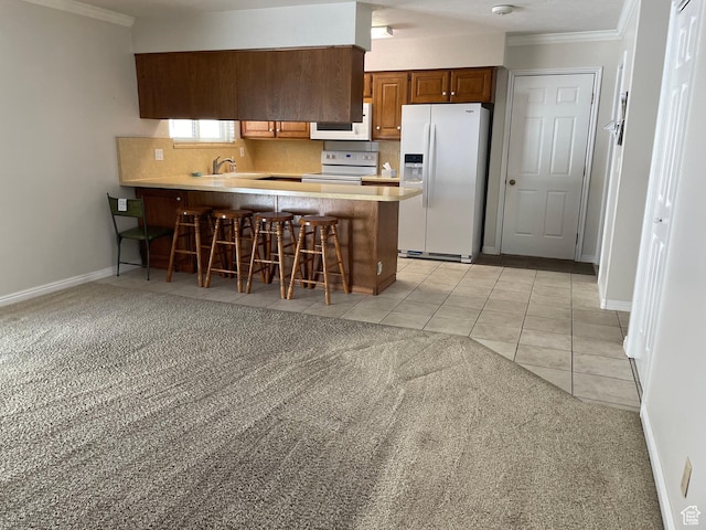 1846 E 9800 S, Sandy, UT 84092 - kitchen with a kitchen breakfast bar, crown molding, a peninsula, light carpet, and white appliances