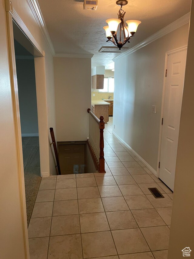 1846 E 9800 S, Sandy, UT 84092 - corridor featuring visible vents, tile patterned flooring, an upstairs landing, a notable chandelier, and ornamental molding
