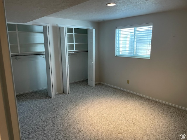 1846 E 9800 S, Sandy, UT 84092 - unfurnished bedroom with a textured ceiling, multiple closets, light colored carpet, and baseboards