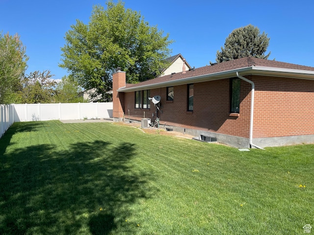 1846 E 9800 S, Sandy, UT 84092 - rear view of property featuring brick siding, a fenced backyard, a chimney, cooling unit, and a yard