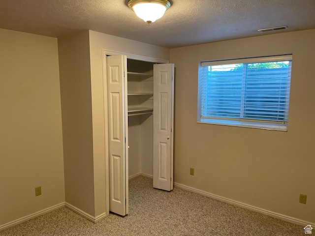 1846 E 9800 S, Sandy, UT 84092 - unfurnished bedroom featuring a textured ceiling, visible vents, light carpet, and a closet