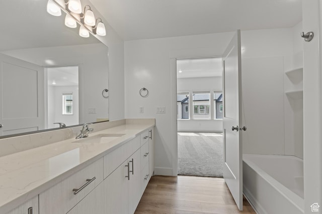 3372 S 1010 W, Nibley, UT 84321 - full bathroom with a bath, vanity, baseboards, and wood finished floors