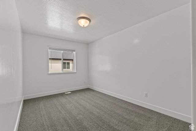 3372 S 1010 W, Nibley, UT 84321 - empty room with dark carpet, a textured ceiling, and baseboards