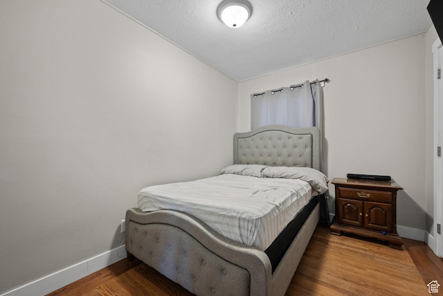 4207 W 5655 S, Salt Lake City, UT 84118 - bedroom featuring a textured ceiling, baseboards, and wood finished floors