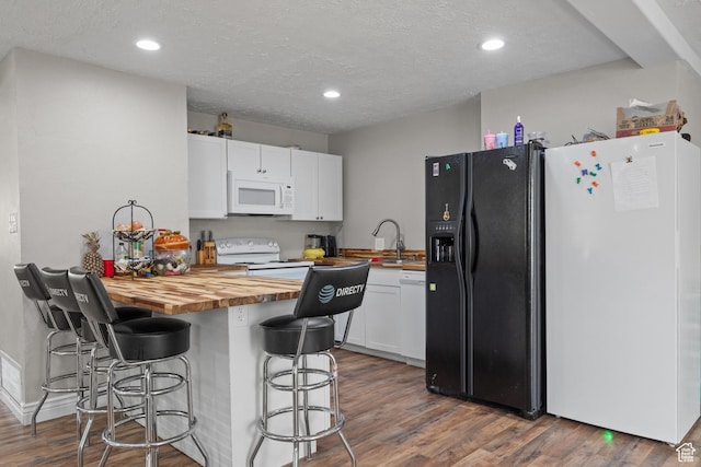 4207 W 5655 S, Salt Lake City, UT 84118 - kitchen with wooden counters, a breakfast bar area, white appliances, and white cabinetry