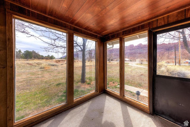 3971 S Spanish Valley Dr, Moab, UT 84532 - unfurnished sunroom with a healthy amount of sunlight, wooden ceiling, and carpet flooring