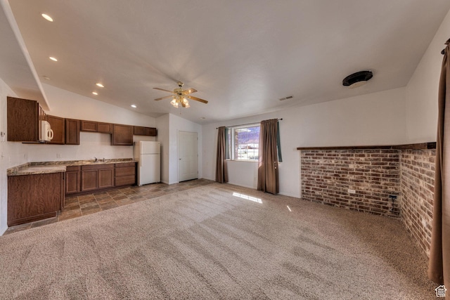 3971 S Spanish Valley Dr, Moab, UT 84532 - unfurnished living room featuring visible vents, light carpet, ceiling fan, a sink, and vaulted ceiling