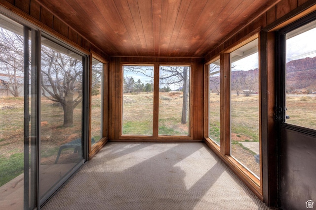 3971 S Spanish Valley Dr, Moab, UT 84532 - unfurnished sunroom featuring a mountain view, wooden ceiling, and carpet