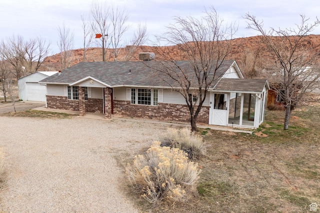 3971 S Spanish Valley Dr, Moab, UT 84532 - ranch-style house with a garage, a shingled roof, concrete driveway, and brick siding
