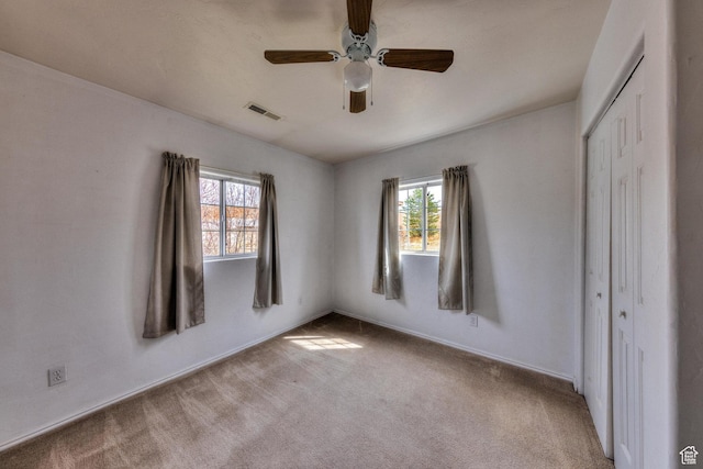 3971 S Spanish Valley Dr, Moab, UT 84532 - unfurnished bedroom with carpet floors, visible vents, multiple windows, and a closet