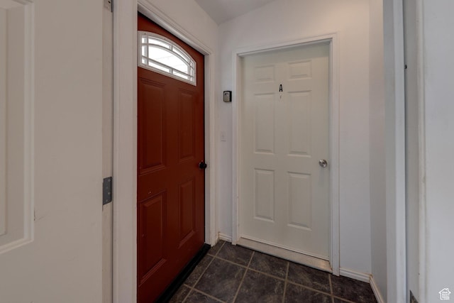 3971 S Spanish Valley Dr, Moab, UT 84532 - doorway to outside featuring dark tile patterned flooring and baseboards