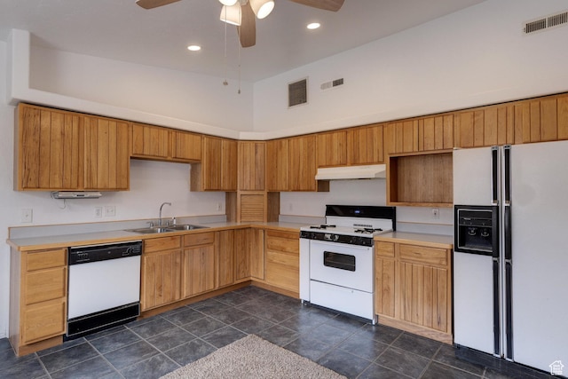 3971 S Spanish Valley Dr, Moab, UT 84532 - kitchen with a sink, under cabinet range hood, white appliances, and visible vents