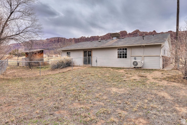 3971 S Spanish Valley Dr, Moab, UT 84532 - rear view of house featuring a lawn, ac unit, and fence