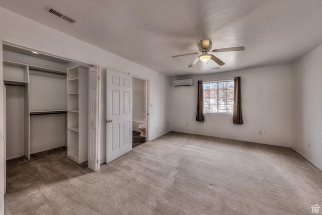 3971 S Spanish Valley Dr, Moab, UT 84532 - unfurnished bedroom featuring carpet floors, visible vents, a wall unit AC, and ensuite bath
