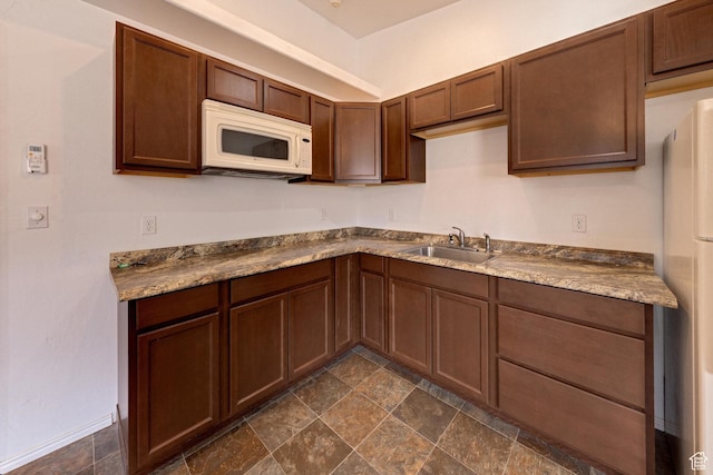 3971 S Spanish Valley Dr, Moab, UT 84532 - kitchen featuring a sink, stone finish floor, and white microwave
