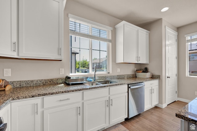 2770 S Sinbad Way W, Magna, UT 84044 - kitchen featuring stainless steel dishwasher, light wood-type flooring, a sink, stone countertops, and white cabinetry