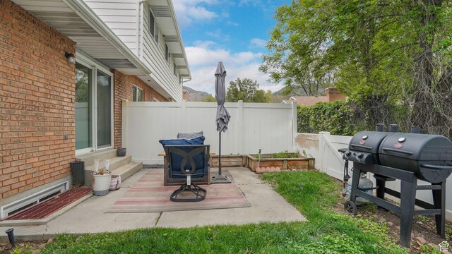 875 E 1150 S Unit 21, Ogden, UT 84404 - view of patio featuring fence, grilling area, and entry steps