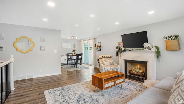 875 E 1150 S Unit 21, Ogden, UT 84404 - living room featuring recessed lighting, a fireplace with flush hearth, wood finished floors, and an inviting chandelier