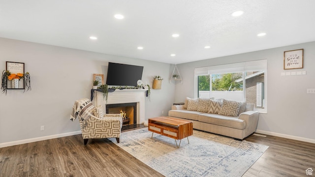 875 E 1150 S Unit 21, Ogden, UT 84404 - living room featuring recessed lighting, baseboards, wood finished floors, and a lit fireplace